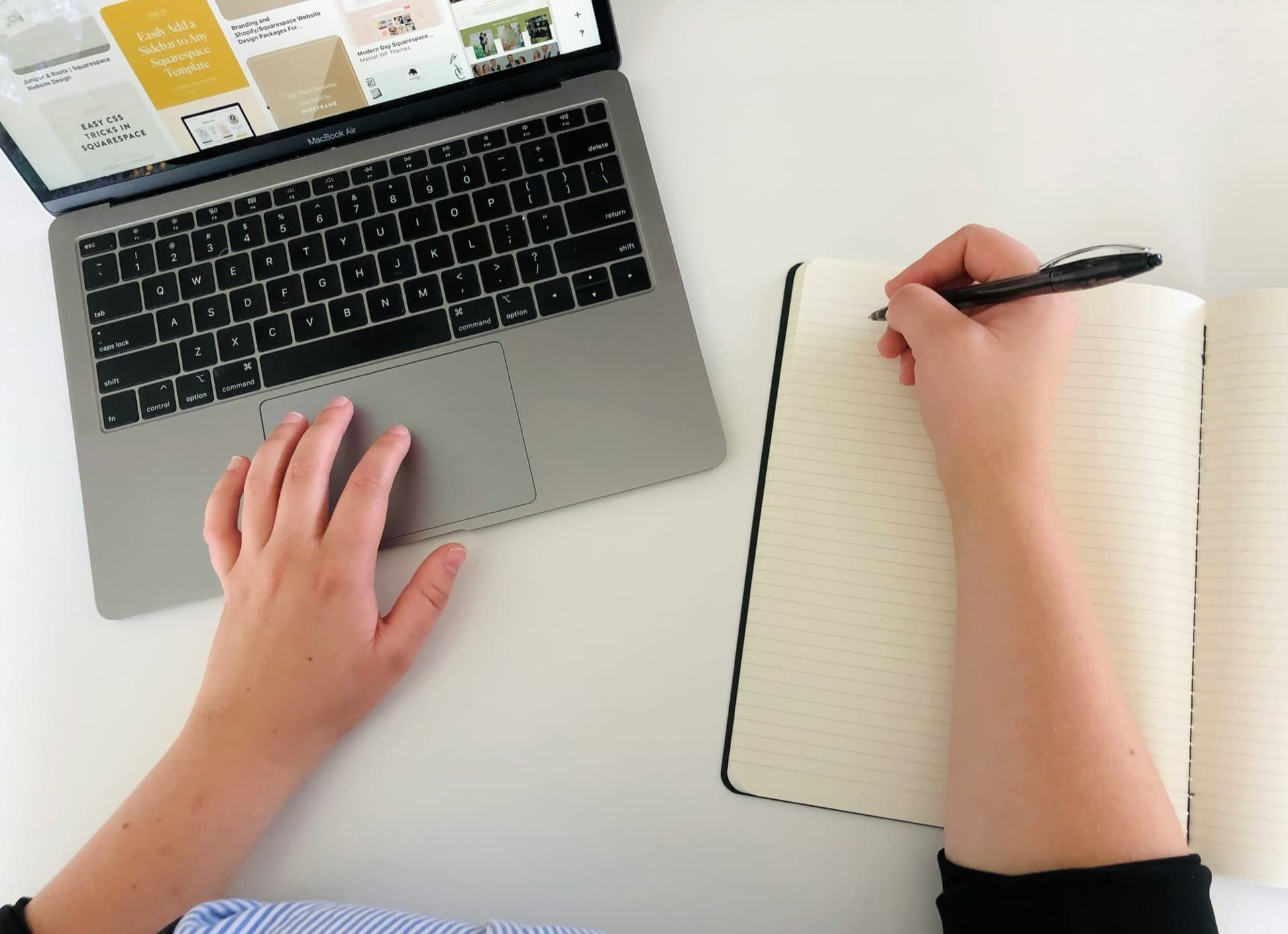A laptop and notebook on a desk for focused work
